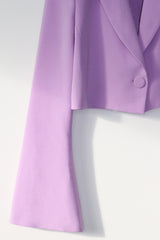 Cropped, oversized, boxy blazer with full length flared sleeves and an single button closure. Custom made in a woven stretch crepe fabric.