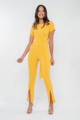 Fitted, mid-rise pant with front slits at hem, centre front and back seams. Custom made in champagne woven stretch crepe fabric.