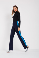 Fitted, high-waist navy coloured pant with turquoise panels on either leg, cut-out detail along hem. Slight stretch, elastic waistband. Made in a woven stretch crepe fabric.