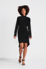 Classic little black dress featuring mock neckline, open cowl back, hi-low hemline, invisible zippers at sleeves. Made in a black triacetate fabric. 